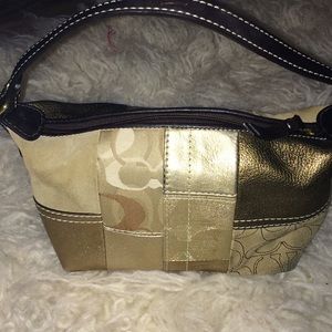 Brown and gold Coach wrist bag